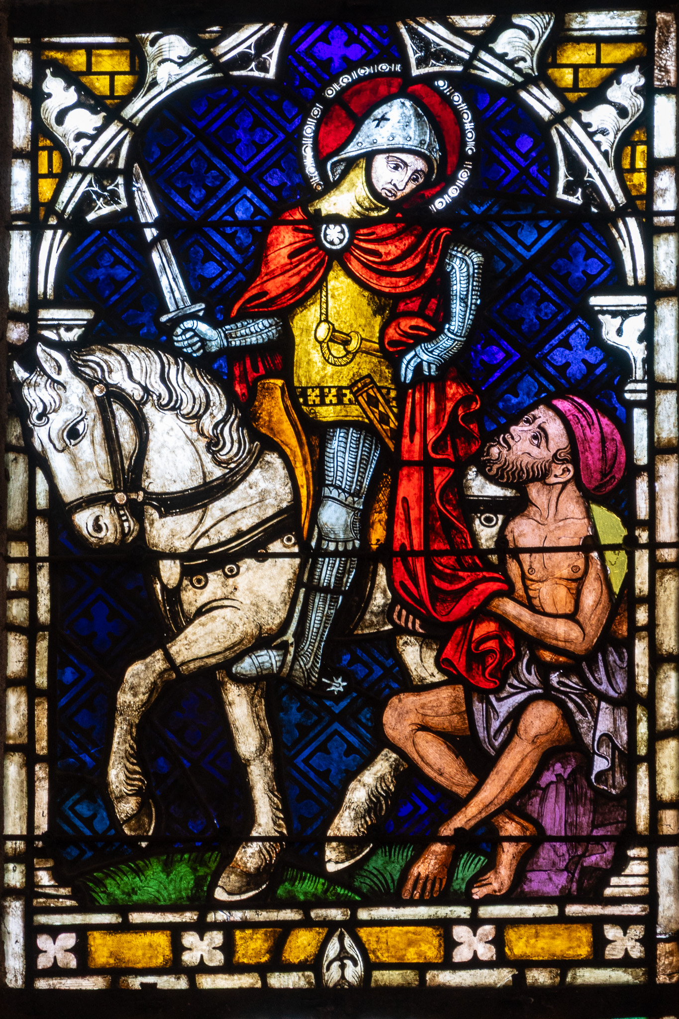 Vitrail représentant saint Martin partageant son manteau avec un homme, dans la collégiale Saint-Martin de Colmar