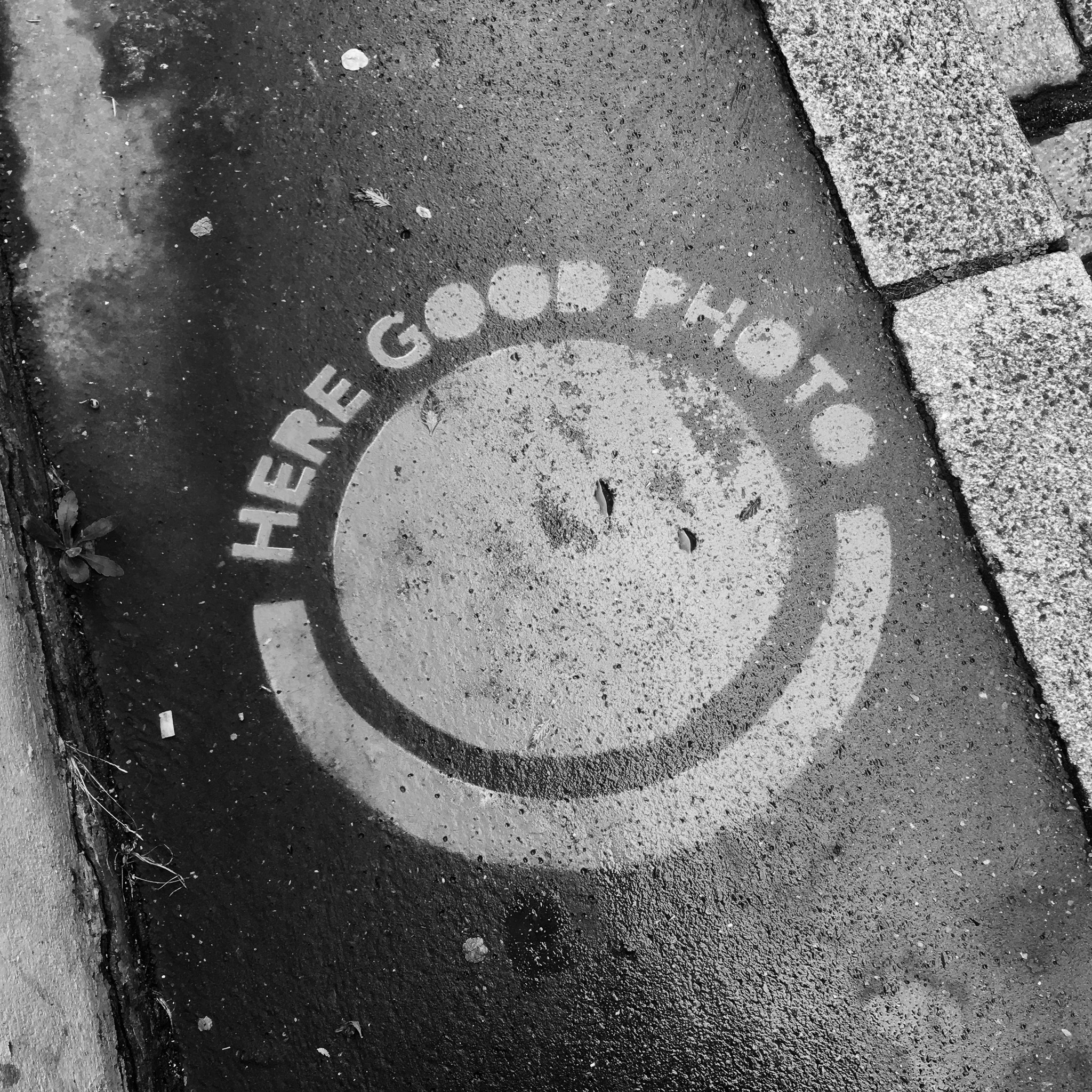 Smiley et inscription Here Good Photo peints en blanc sur le sol